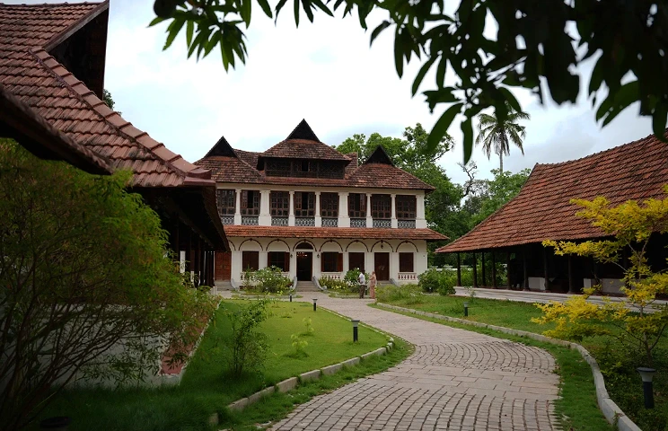 Traditional Kerala heritage building with a brick path